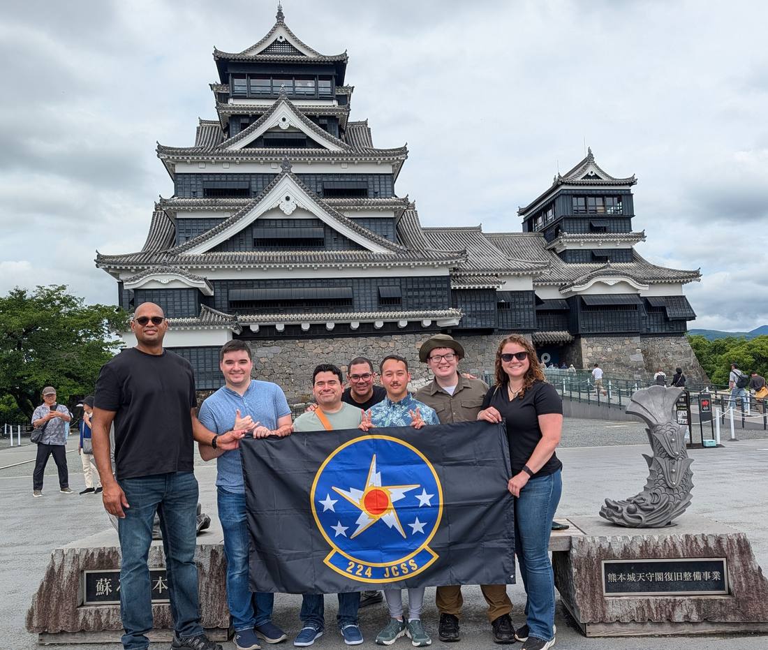 224th JCSS team with the squadron flag at Kumamoto Castle, Japan